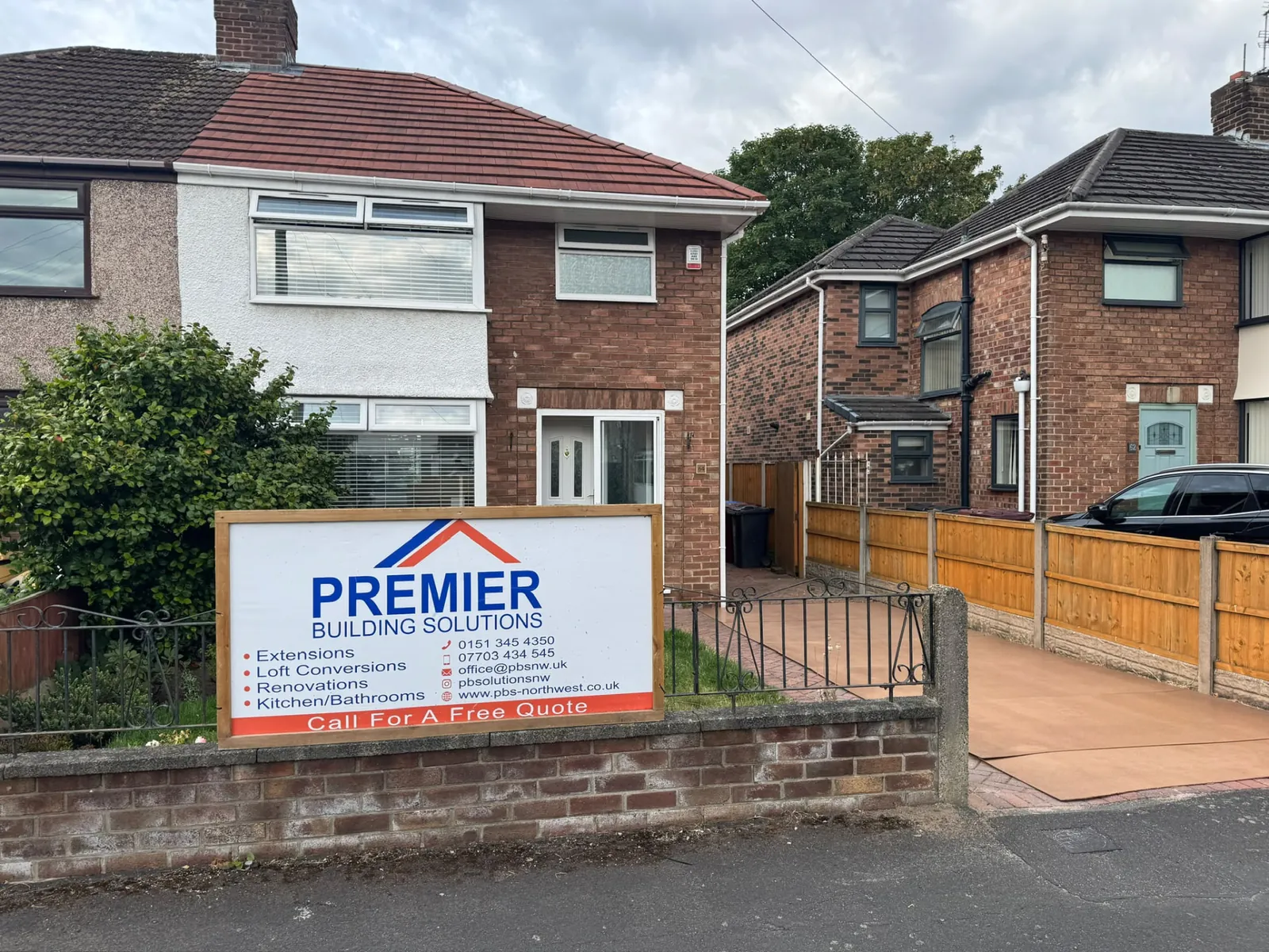 Premier Building Solutions site board outside a house in Merseyside