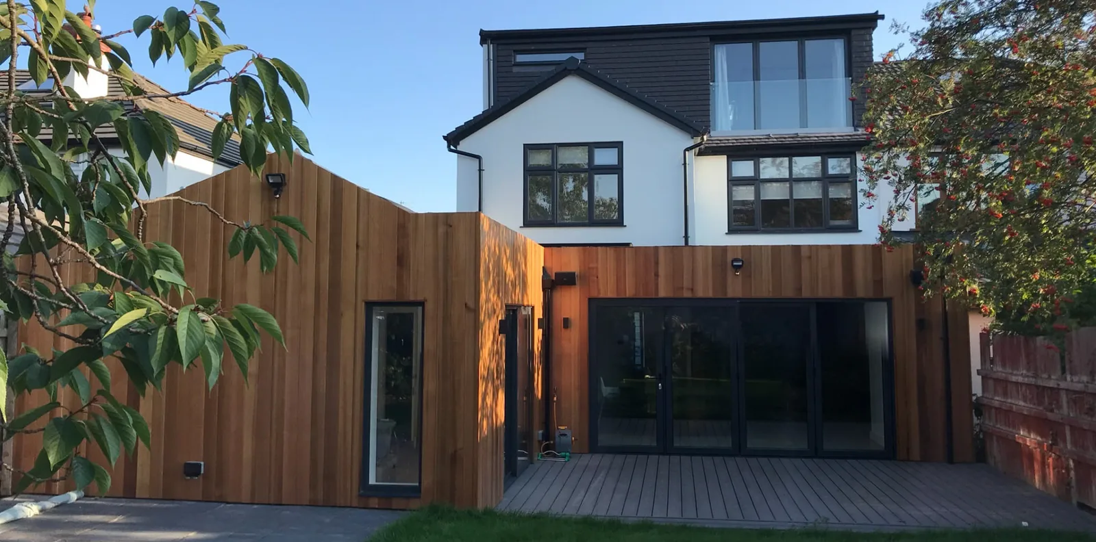 Finished dormer loft conversion above a timber-clad rear extension in Liverpool